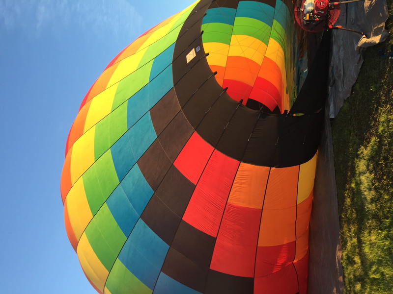 outdoors, mid-air, aircraft, hot air balloon, hot, multicolored, balloon, sky, celebration, ground, blue, pattern, air, no people, ballooning festival