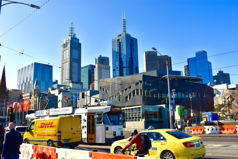 tall - high, skyscraper, cityscape, nature, tower, city life, built structure, sky, street, land vehicle, melbourne, outdoors, building exterior, transportation