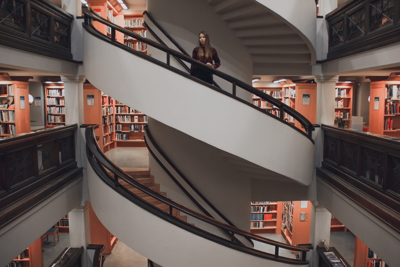 indoors, standing, railing, library, steps and staircases, interior, spiral, bookshop, urban, stairwell, built structure, book, interior design, city, library interior