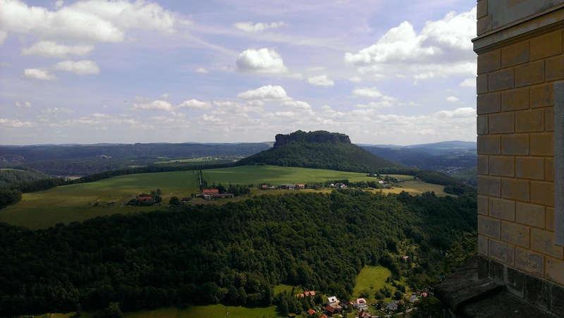 land, beauty in nature, lily stone, environment, mountain, building exterior, day, sandstone mountain, tranquility, fortress, landscape, cloud - sky, panoramic view to the lilienstein