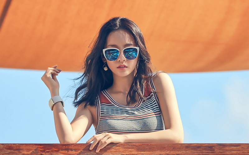 beauty, outdoors, kpop, fashion, looking at camera, young adult, sitting, glasses, hara, front view, real people, lifestyles, sunglasses, leisure activity