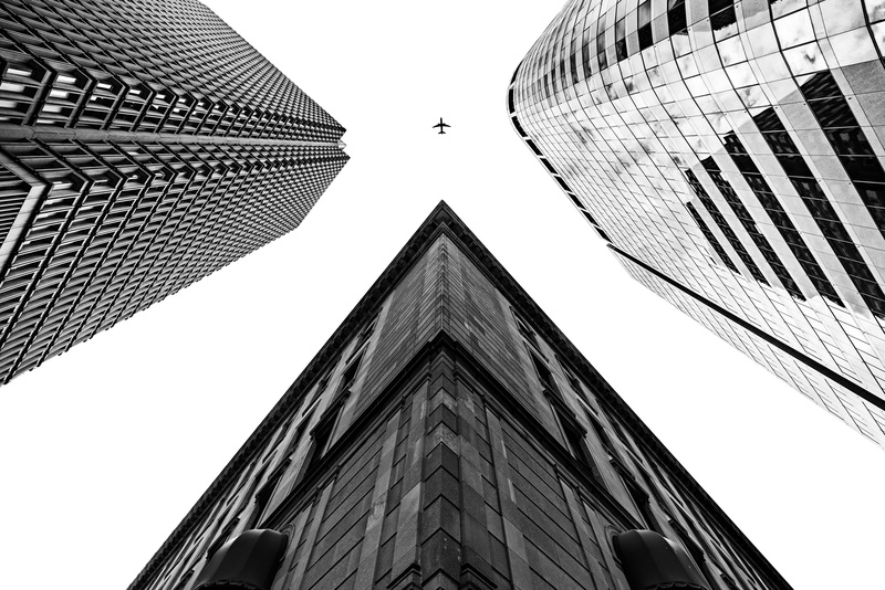 cityscape, glass - Material, city Life, built Structure, tall - High, no People, airplane, steel, facade, urban Scene, famous Place, grayscale, financial District