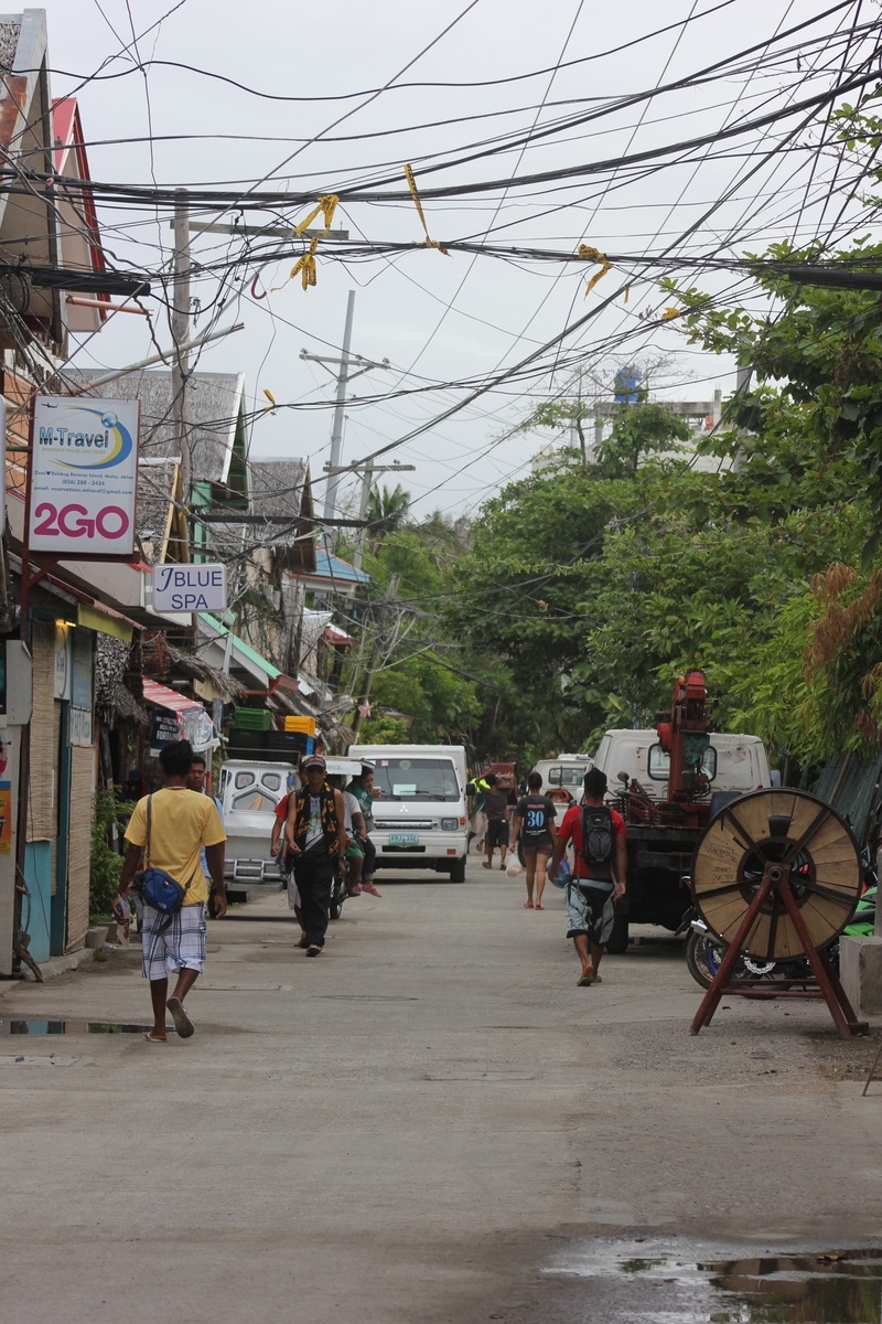 people, transportation, road, real people, architecture, street, cables, land vehicle, tree, men, group of people, tourists, city, overhead, outdoors, walking