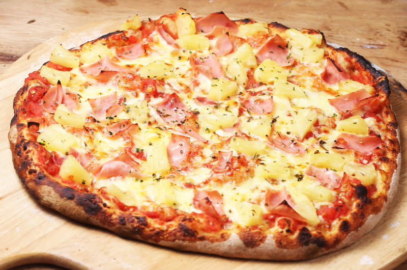 wood - material, pizza, fast food, cheese, indulgence, city, snack, high angle view, vegetarian food, food and drink, close-up, food, still life, ready-to-eat