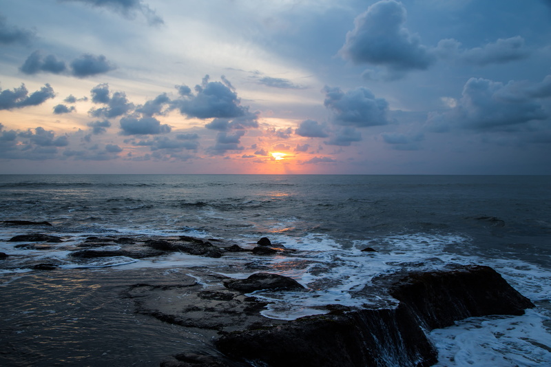 tranquil scene, motion, beauty in nature, tranquility, outdoors, tanah lot temple, horizon, aquatic sport, clouds, sunset, no people, indonesia, scenics - nature