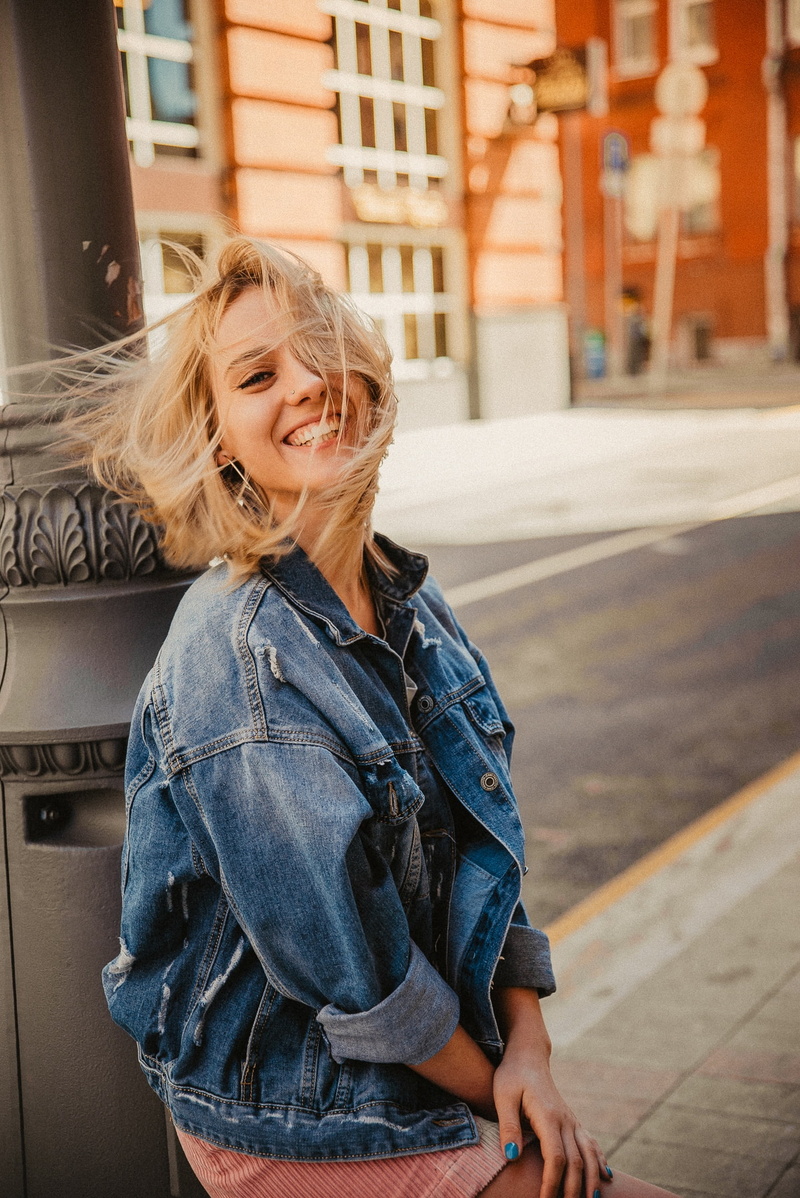 smiling, architecture, beauty, outdoors, portrait, city, emotion, women outdoors, hair, urban, miniskirt, jeans jacket, model, hairstyle, portrait display