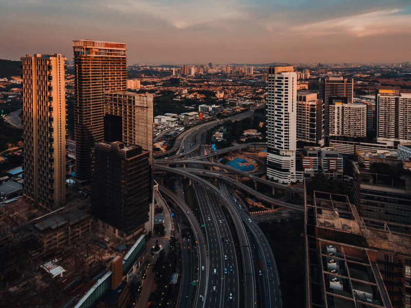 tower, modern, route, car, built structure, sunset, multiple lane highway, high angle view, skyscraper, highway, road, cloud - sky, transportation, petaling jaya