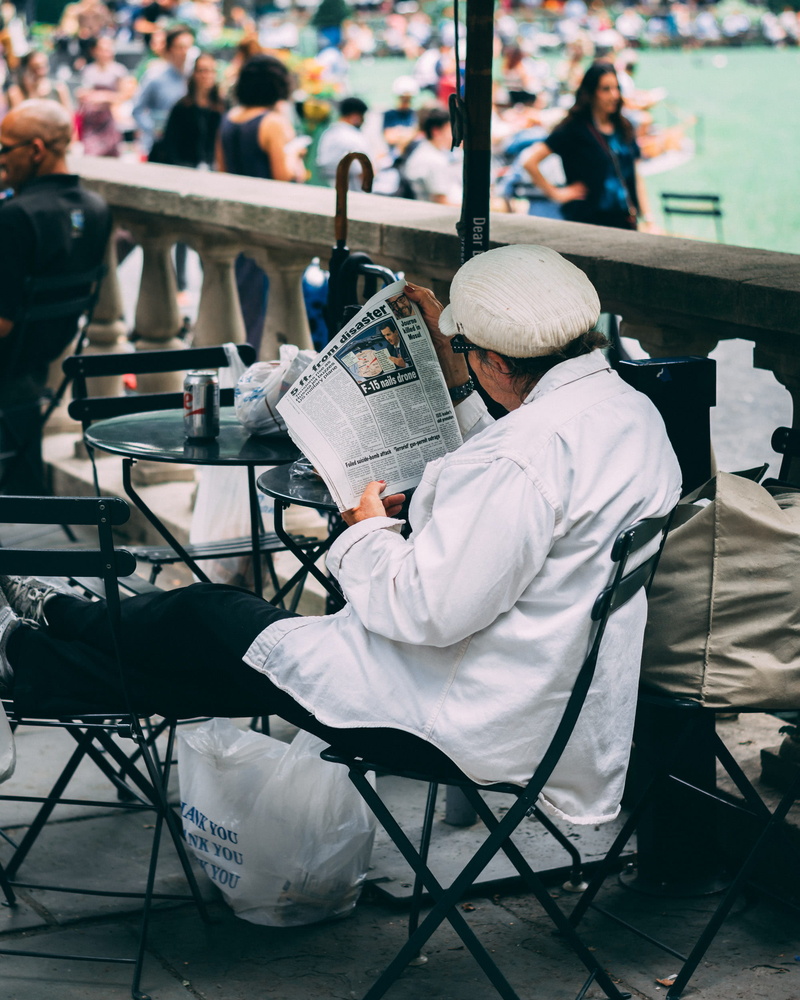 uniform, cityscape, news, adult, black, portrait, nyc, white, seat, clothing, water, paper, day, sitting, body, city, relaxing, enjoying, old, people, full length