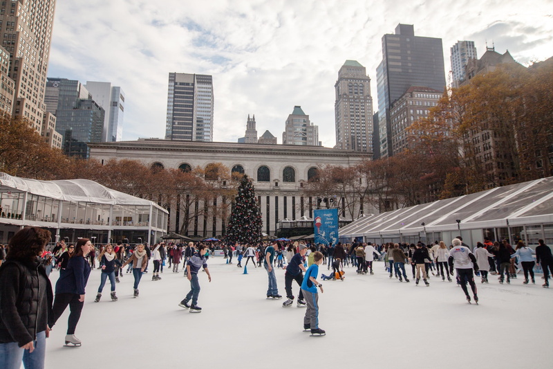 inline, wintertime, winter sport, skates, real people, ice, ice-skating, skating, office building exterior, outdoor, new york city, crowd, large group of people