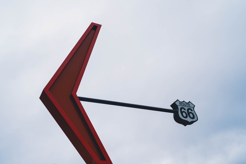 metal, cloud - sky, sign, flagstaff, outdoors, minimal, no people, day, lighting equipment, direction, guidance, route, symbol, arrow symbol, direction way