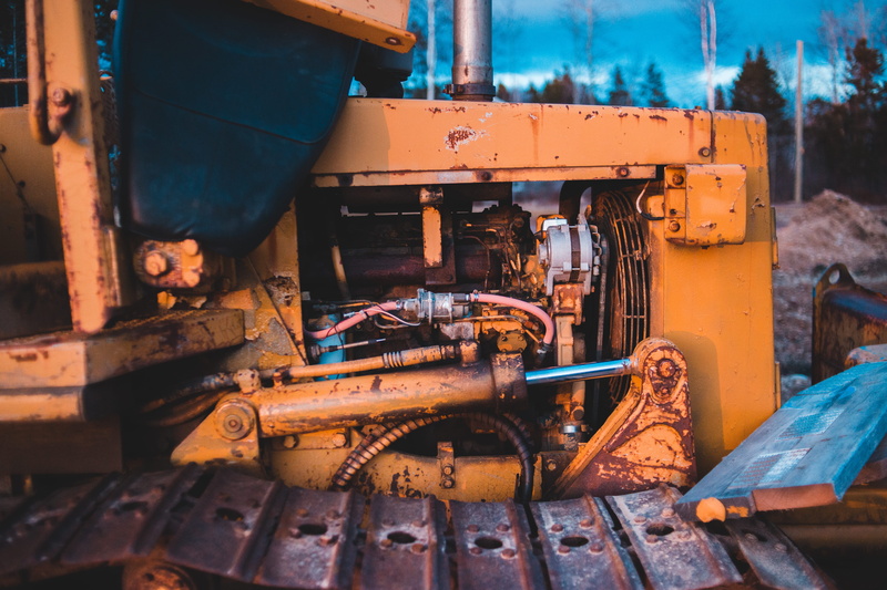 no people, machinery, engine, bulldozer, vehicle, building, nature, manufacturing, outdoors, transportation, machine, mode of transportation, abandoned