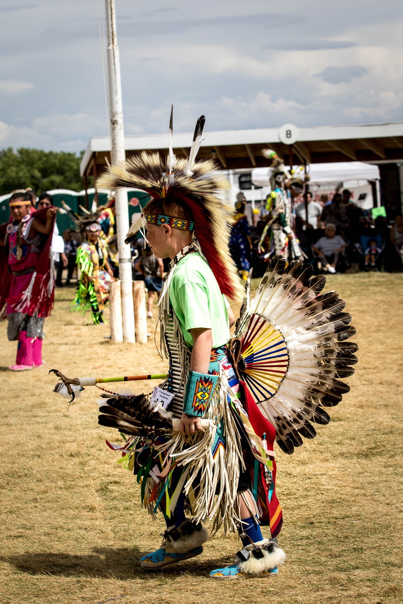 Arapahoe, outdoors, people, leisure activity, pow wow, Tribe, full length, men, clothing, lifestyles, costume, sunlight, culture, crowd, ritual, real people