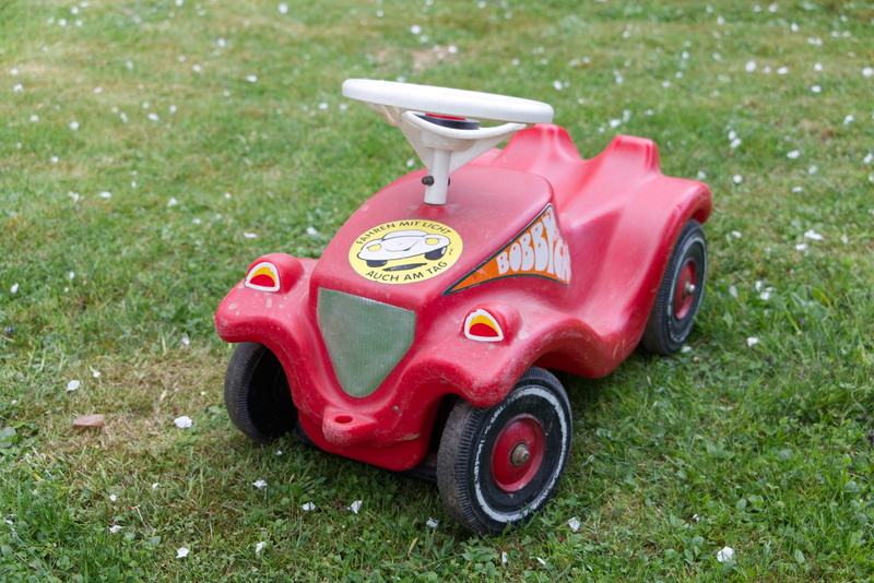 land, mini car, field, outdoors, bobby car, mode of transportation, children vehicle, toy car, children toys, green color, toy, plastic, auto, car, transportation