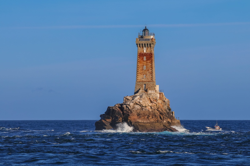 rock formation, sky, horizon over water, clear sky, waterfront, guidance, rock - object, boat, tower, blue, sea, building exterior, water, no people, lighthouse