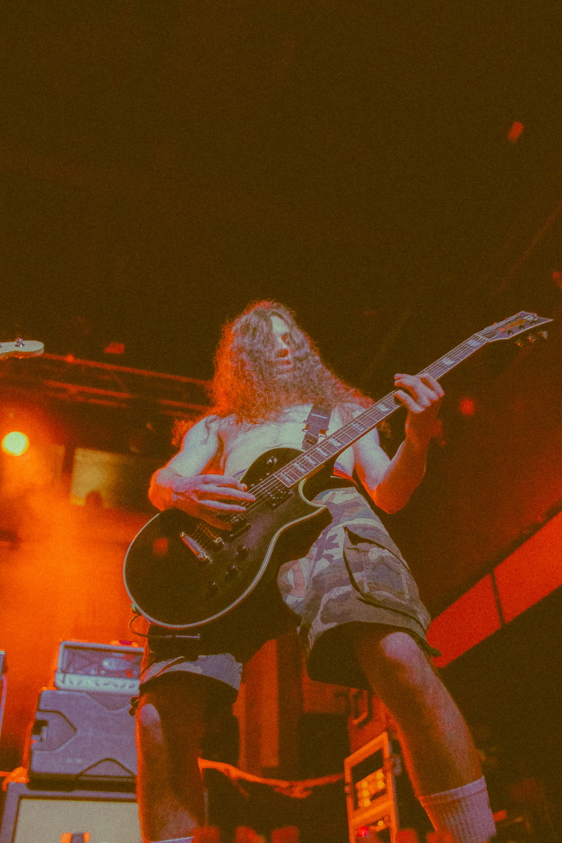 leisure activities, music band, performer, lifestyles, gray, architecture, bass guitar, leisure activity, rear view, childhood, illuminated, crowd, one person
