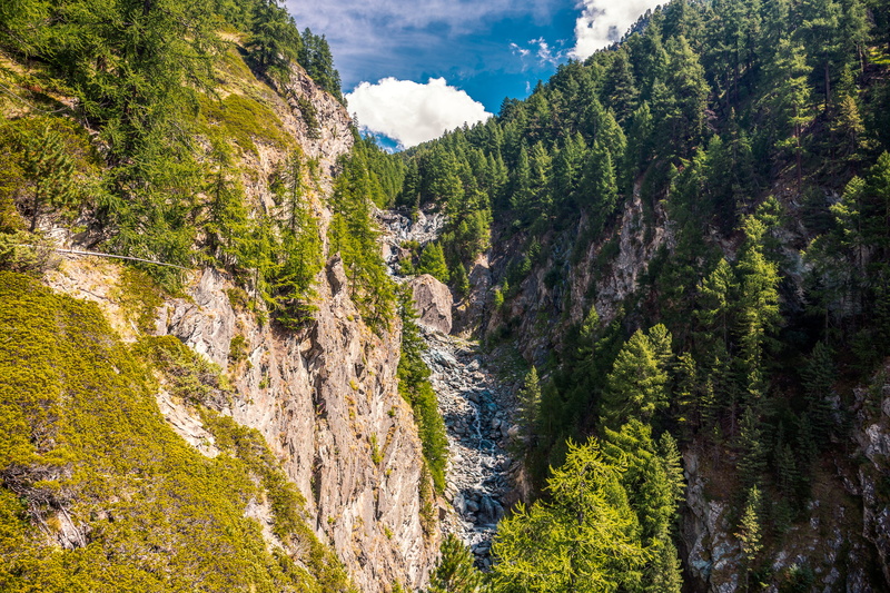 waterfall, non-urban scene, tree, environment, green color, water, nature, flowing, cloud - sky, cliff, green, trees, grey, forest, sky, growth, switzerland