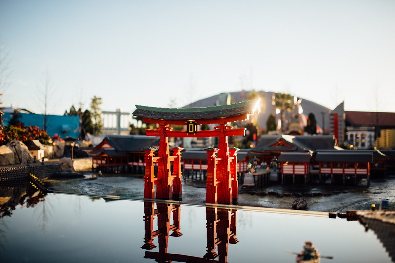 clear sky, red, machine, belief, gate, water, kiosk, architecture, waterfront, building exterior, worship, lake, sky, building, incidental people, urban