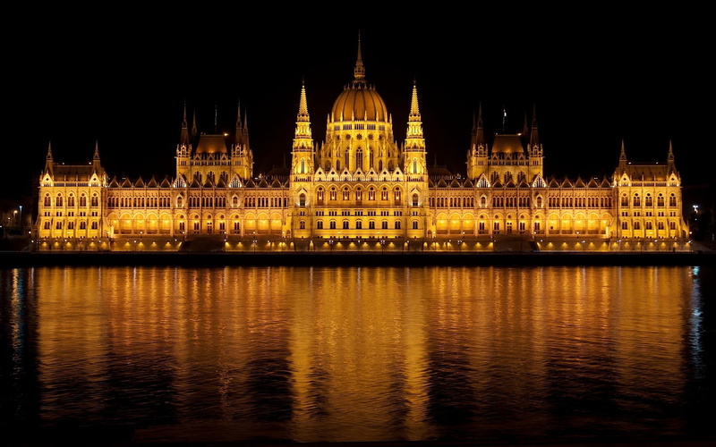 river, water, building exterior, tourism, sky, illuminated, waterfront, travel destinations, spire, no people, building budapest hungary hungarian parliament building