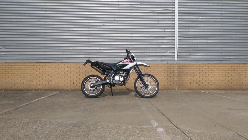 city, wall - building feature, transportation, no people, sport, bike, store, land vehicle, wr, full length, side view, motorcycle, architecture, day, wheel