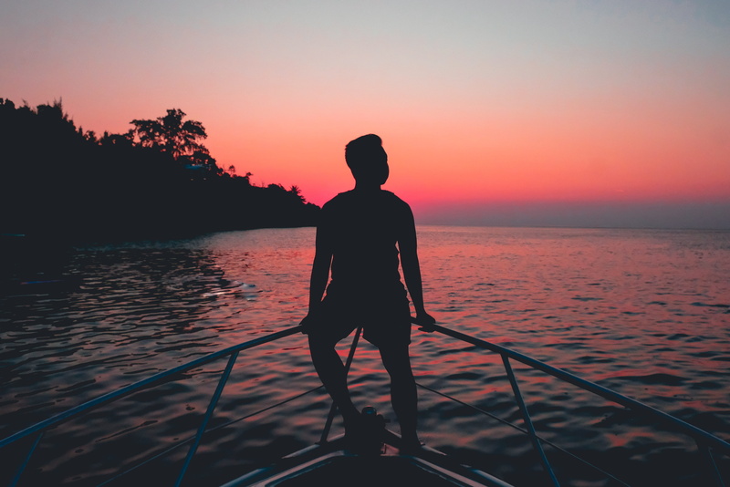 chill, horizon over water, horizon, man, leisure activity, looking at view, boat bow, real people, nature, fence, hour, scenics - nature, silhouette, tranquil scene