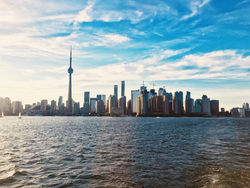 travel destinations, canada, tall - high, urban skyline, architecture, spire, building exterior, skyscraper, cloud - sky, water, city, landscape, built structure