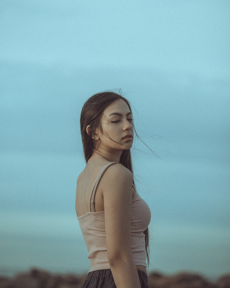 eyes closed, sky, female, eyes, waist up, fashion, long hair, beautiful woman, casual clothing, woman, leisure activity, one person, daytime, portrait