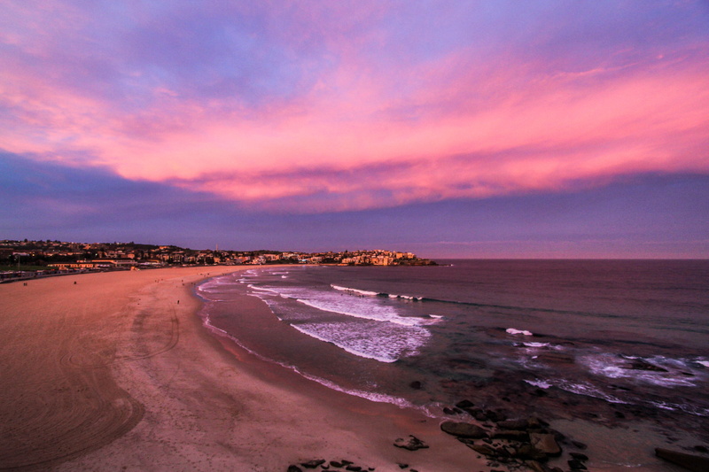 coastline, purple, coast, travel, wave, pink color, sky, sea, surf, horizon over water, outdoors, tranquility, cliff, tropcial, aquatic sport, motion, bay
