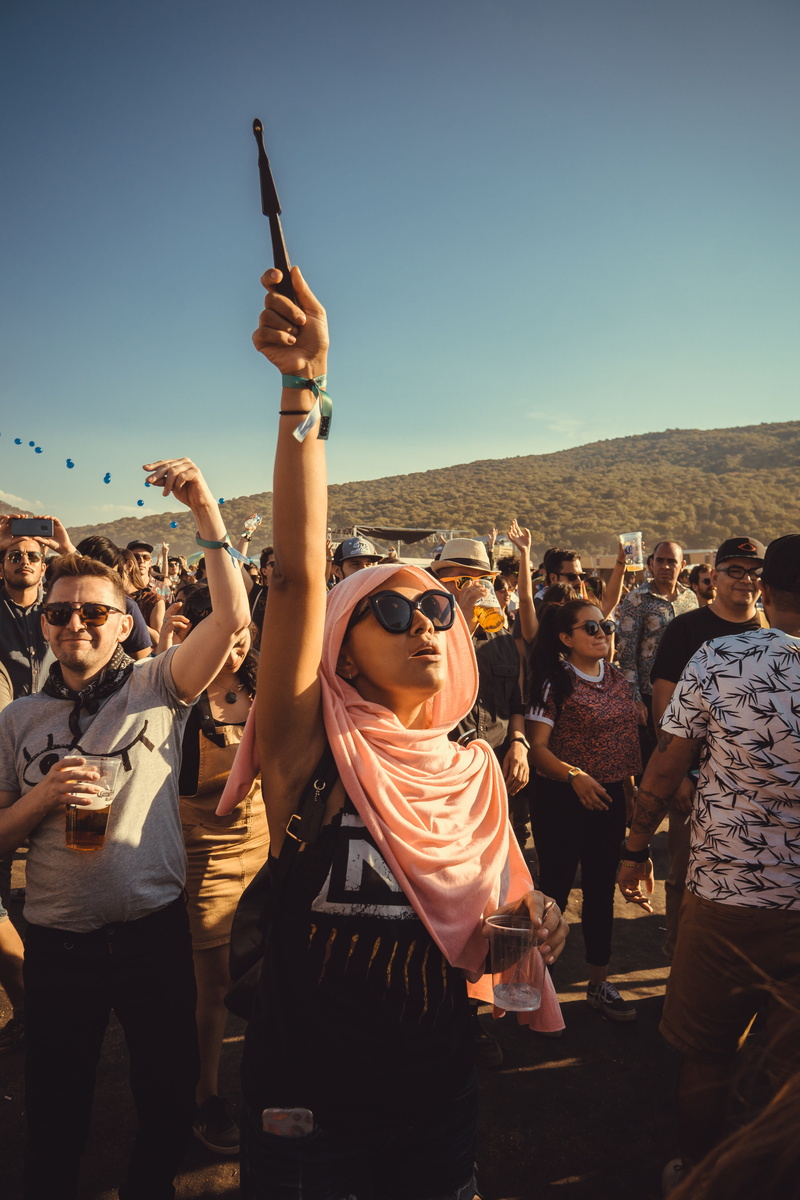 adult, sky, spring break, emotion, crowd, vacation, apparel, festival goer, tourist, real people, young women, mobile phone, women, holding, accessory