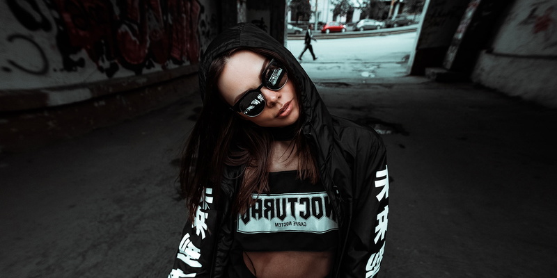 fisheye lens, text, architecture, jacket, fashion, three quarter length, looking at camera, brunette, outdoors, women, lifestyles, young adult, street