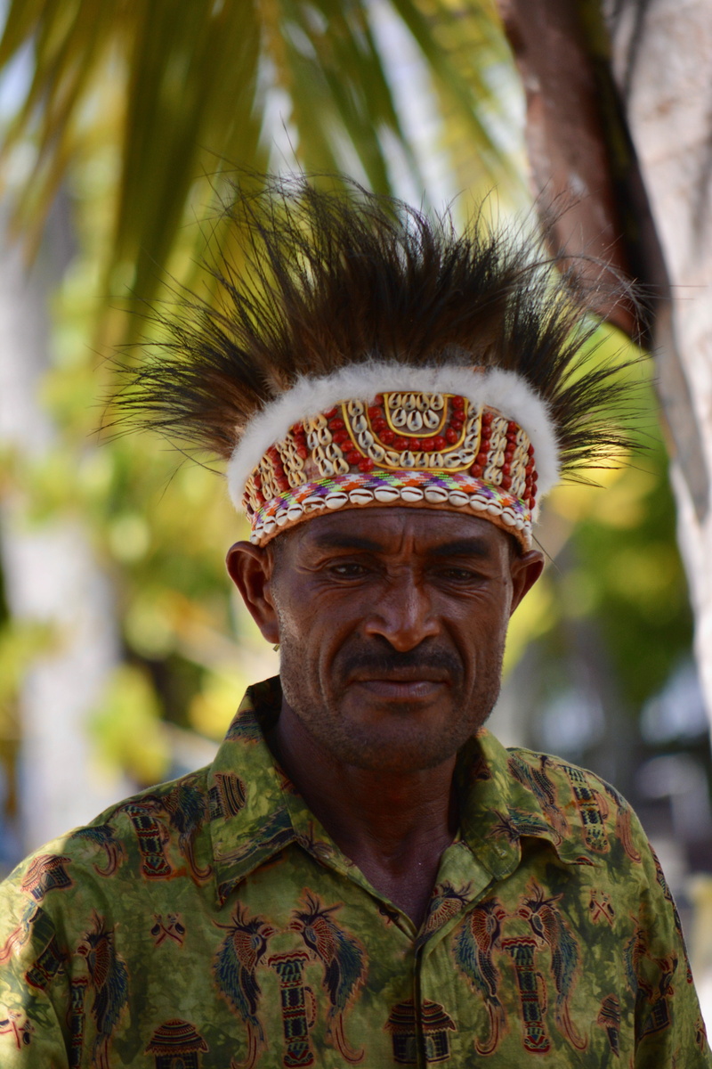 close-up, human face, lifestyles, one person, raja ampat islands, tree, males, indonesia, looking at camera, men, leisure activity, headshot, mature adult