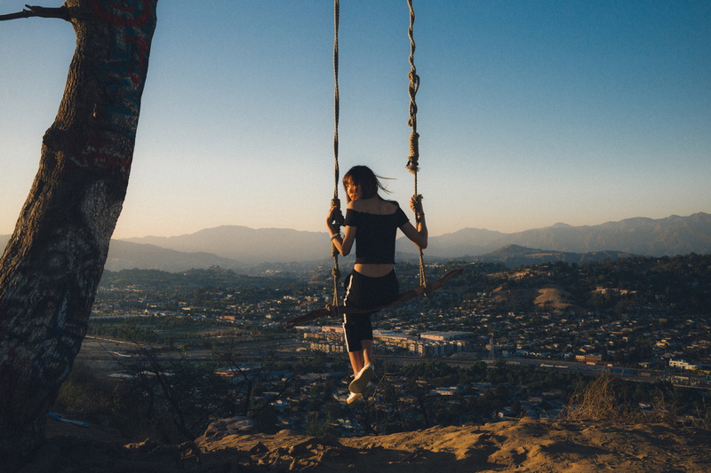 sky, outdoors, enjoyment, hanging, leisure activity, people, real people, swing, sunlight, casual clothing, mountain, lifestyles, rope, nature, fun, day