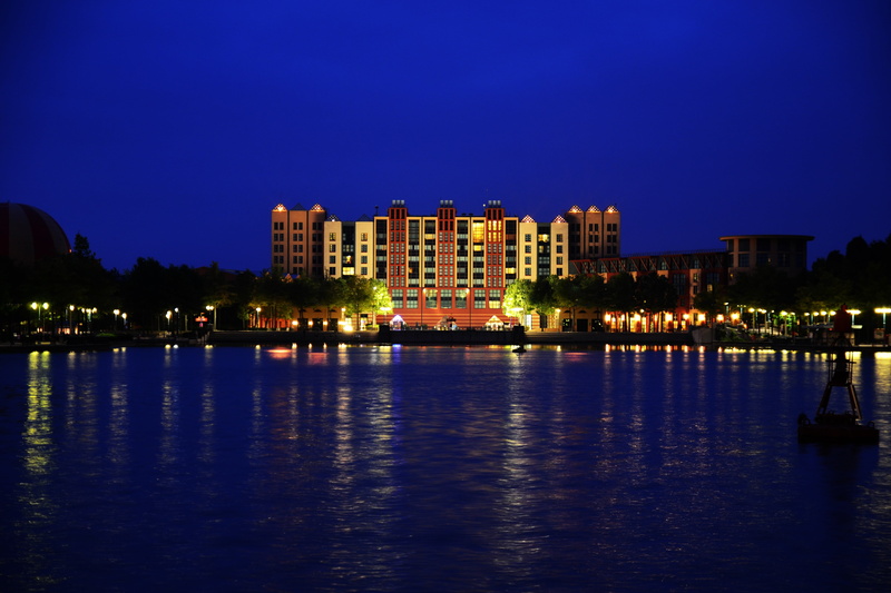 disneyland paris, water, manhatten hotel, twilight, concrete, travel destinations, illuminated, outdoors, red, residential district, night, lake, sky, blue