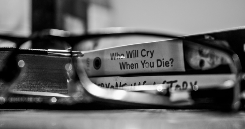grayscale, cry, table, music, black and white, indoors, labeled, western script, book, no people, novel, communication, studio shot, close-up, will, selective focus