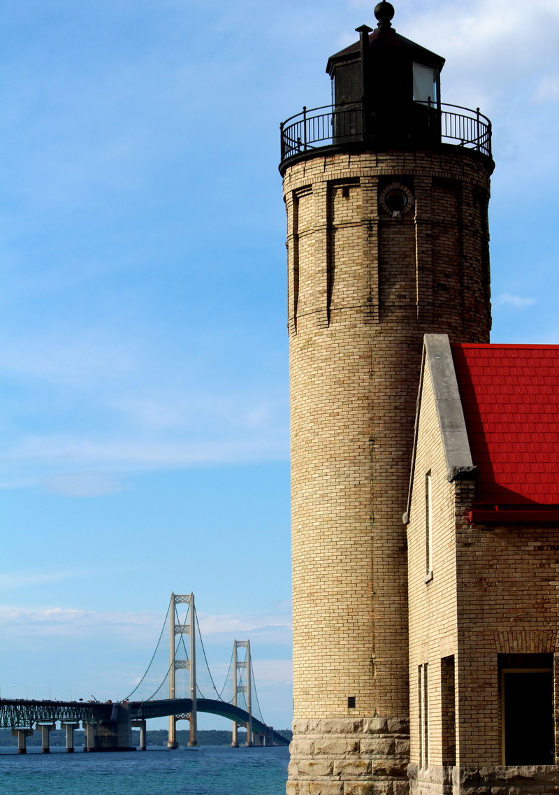 low angle view, sea, great lakes, sky, famous Place, tall - high, blue, tower, lighthouse, cloud - sky, outdoors, building exterior, nature, bay, mackinac bridge