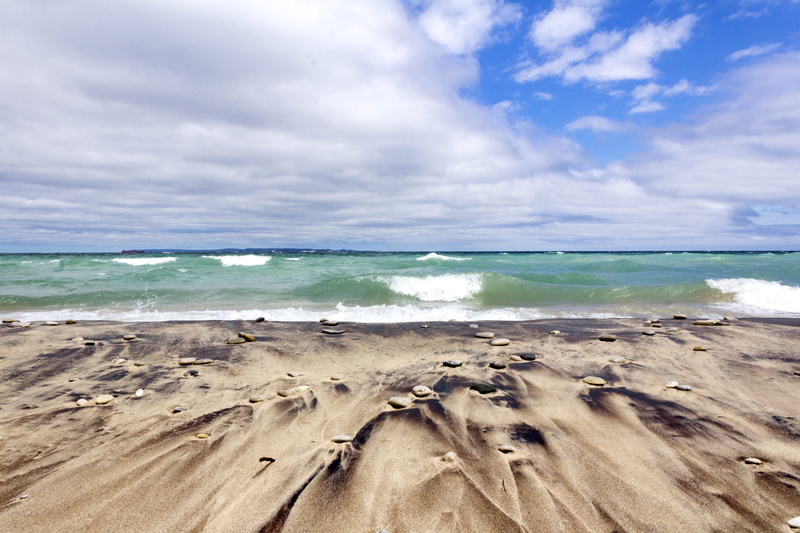 sand, beach, outdoors, water, landscape, clouds, beauty in nature, tranquility, ocean, lake, horizon, idyllic, horizon over water, cloud - sky, sleeping bear dunes national lakeshore