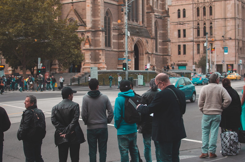 people, city, working, pedestrians, architecture, city street, built structure, rear view, day, walking, lifestyles, road, person, transportation, group of people