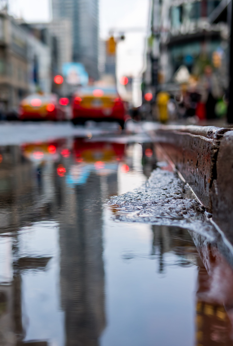 transportation, mode of transportation, outdoors, curb, building exterior, selective focus, built structure, rain, near, street, nature, city, wet, motion