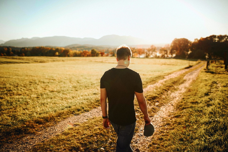 casual clothing, sunlight, rear view, back view, field, mountains, leisure activity, misty, real people, environment, sunset, foggy, day, nature, person