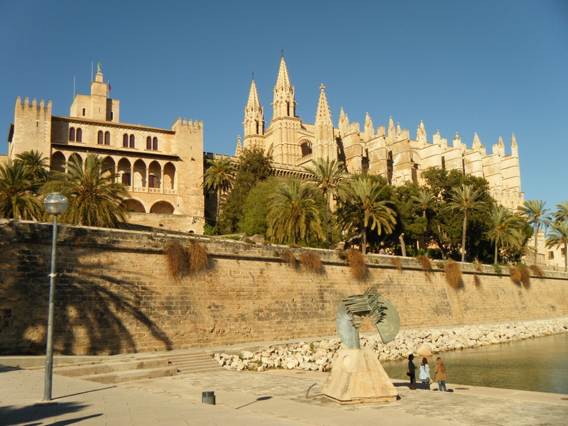 lawn, tree, city, monastery, place of worship, outdoors, clear sky, majorca, view, monument, blue, spain, nature, architecture, tourism, palm tree, tropical climate