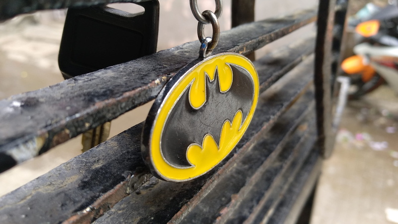 high angle view, metal, wood - material, outdoors, keychain, close-up, mode of transportation, batman, design, yellow, emotion, communication, selective focus