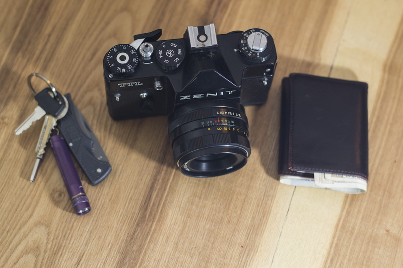 hardwood floor, wood - material, leather, photographic equipment, electronics, flooring, leisure, office, still life, wooden table top, money, digital single-lens reflex camera
