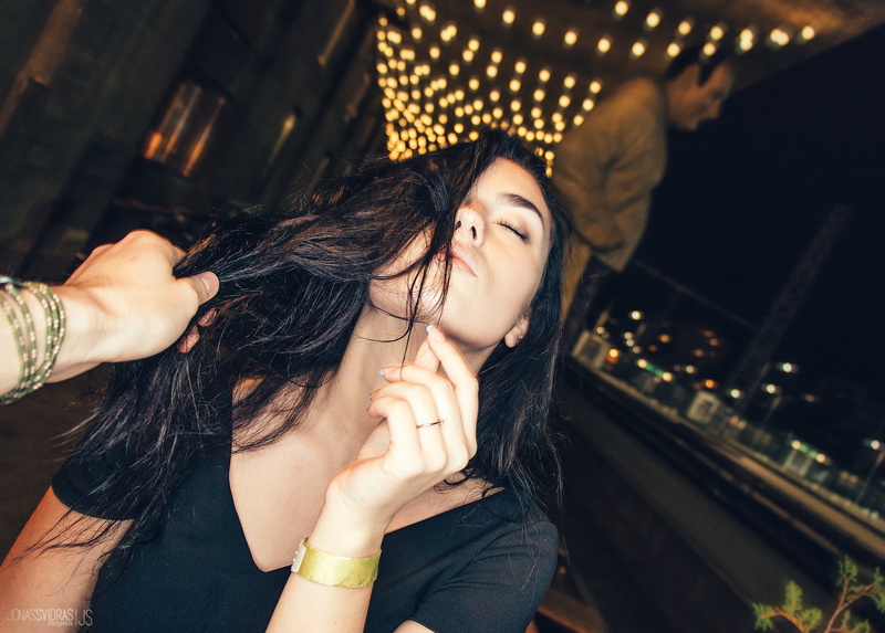 casual clothing, night, depth of field, face, headshot, one person, 1080P, architecture, women, black hair, hair, POV, focus on foreground, illuminated