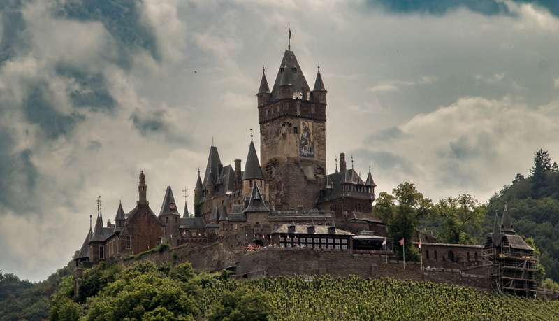 travel destinations, building exterior, outdoors, castle, clouds, cochem, ancient, imperial castle, spire, building, old, tree, imposing, nature, history