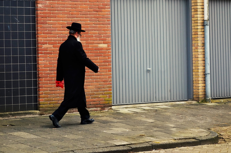 4K, wall, building exterior, adult, one person, building, footpath, jewish man, person, architecture, full length, standing, sidewalk, black color, religious
