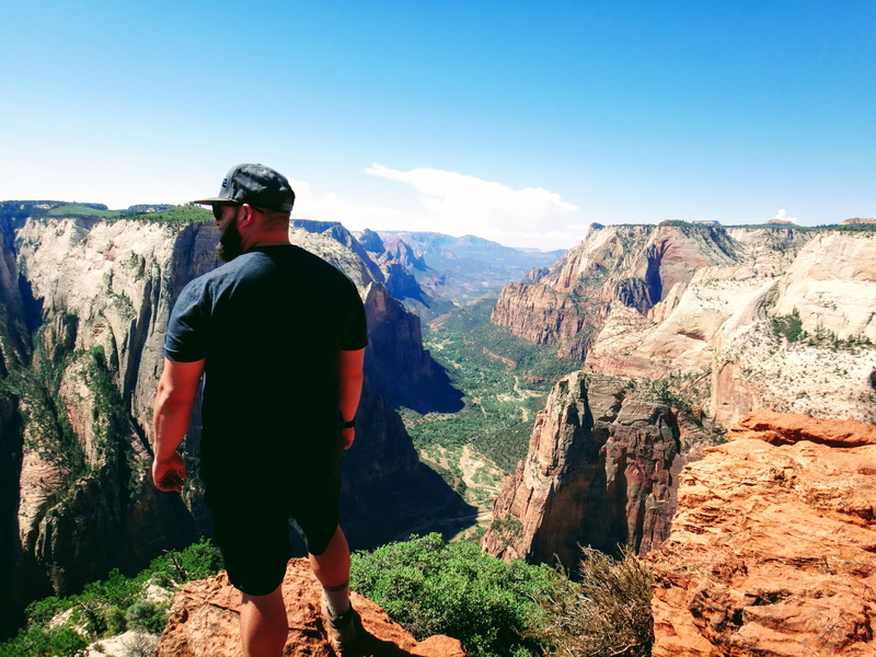 solid, travel, leisure activity, overlook, rear view, hiking, outdoors, mountain, plateau, beauty in nature, one person, blue, non-urban scene, standing