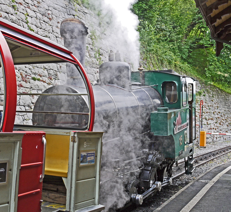 railway line, brienz, motor vehicle, day, public transportation, view mountain, platform, smoke - physical structure, narrow gauge railway, motion, steam train