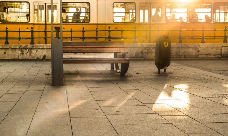 city, building exterior, street, tiled floor, bench, yellow, burst, public transportation, summer, built structure, bin, rail transportation, day, window