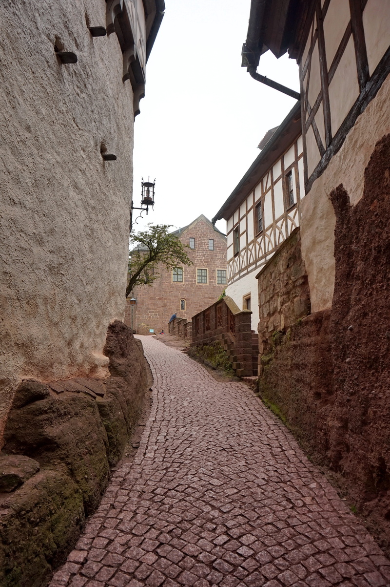 no people, cobblestone, alley, wall - building feature, building, fortress, building exterior, street, built structure, direction, the way forward, day