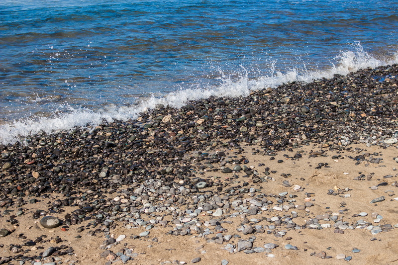 pollution, rock, sport, wave, gran canaria, beach, no people, motion, water, nature, sand, high angle view, rocks, day, beauty in nature, sea, pebble, aquatic sport