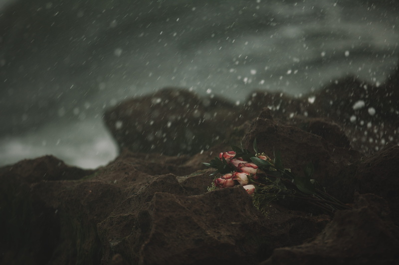rock - object, spray, wet, sky, sadness, raindrop, death, dark, solid, water, love, rock, rocks, rain, no people, sea, snowing, selective focus, outdoors